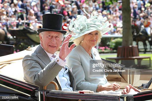 King Charles III and Queen Camilla smiles and wave as they attend day one of Royal Ascot at Ascot Racecourse on June 17, 2025 in Ascot, England.