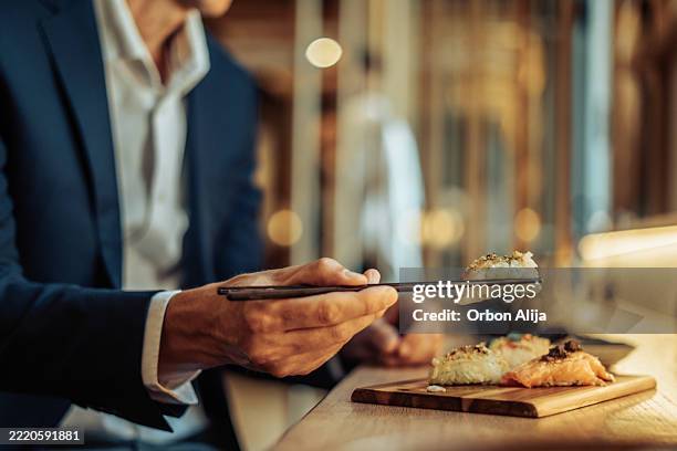 man having dinner at a restaurant - japanese food stock pictures, royalty-free photos & images