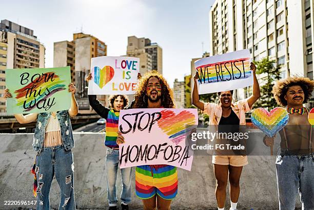 group of lgbtqiapn+ activists protesting against homophobia in the city - homophobia stock pictures, royalty-free photos & images