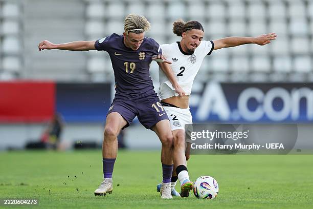 Taylan Bulut of Germany battles for possession with Jesse Derry of England during the UEFA European Under-19 Championship Group B match between...