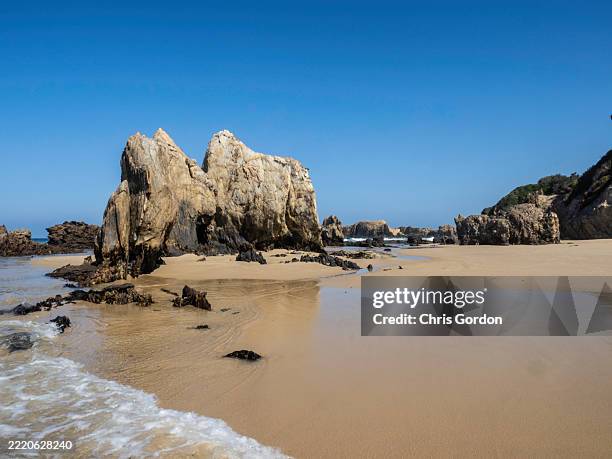 rocky coastline on calm day - rocky coastline stock pictures, royalty-free photos & images