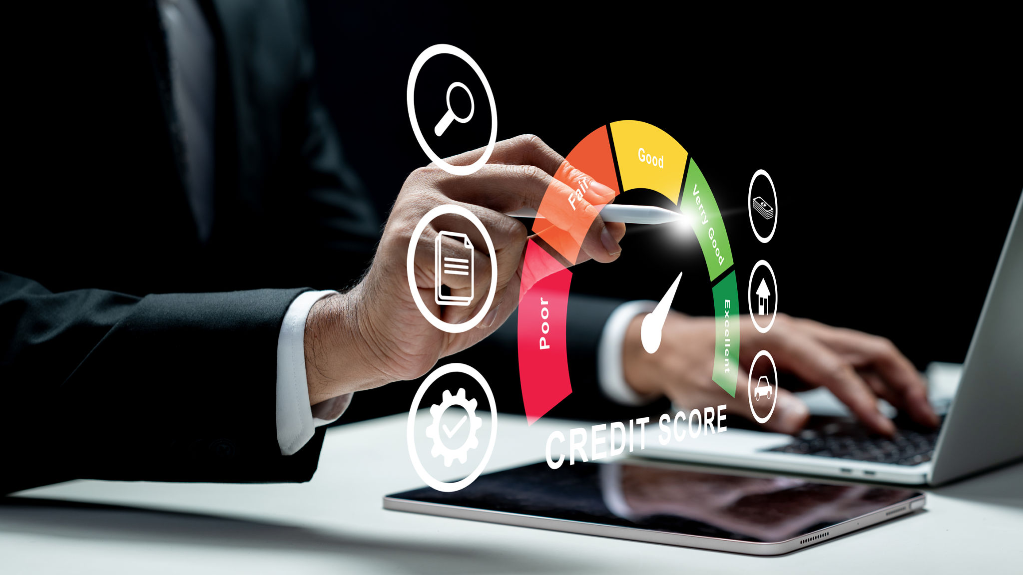 Businessman using a laptop while touching the icon of his credit score on the tablet screen. Technology innovation on a virtual screen. Concept of credit score Businessman using a laptop while touching the icon of his credit score on the tablet screen. Technology innovation on a virtual screen. Concept of credit score