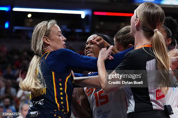Sophie Cunningham of the Indiana Fever and Jacy Sheldon of the Connecticut Sun face off during an altercation in the fourth quarter at Gainbridge...