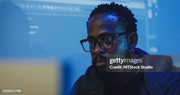 closeup black male engineer programmer work on computer software development strategies in tech office late into the night. software developer, artificial intelligence concept. - java developer stock pictures, royalty-free photos & images