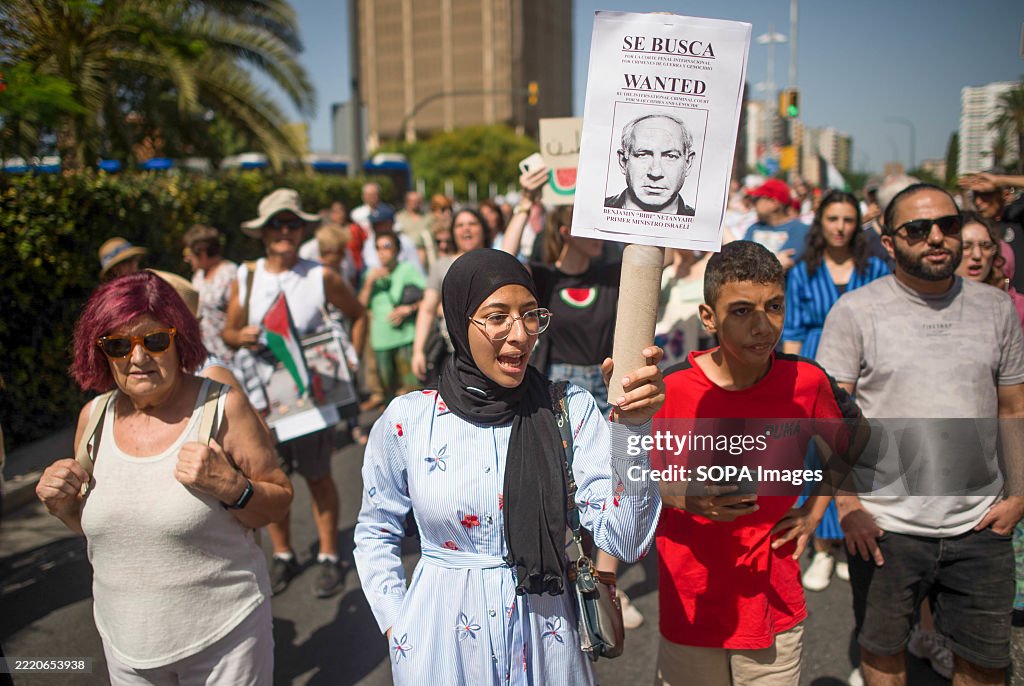 Protestet A protester is seen shouting slogans while holding up a placard with ...