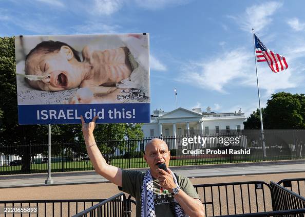 Protesting Babies A demonstrator holding a picture of a baby victim, joins a protest in ...