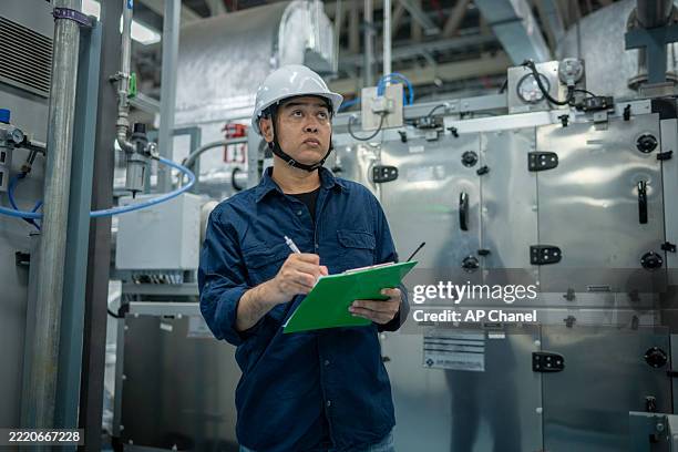 engineers or technicians working extensive metal piping, hvac systems, industrial equipment suggesting a controlled, well-maintained environment concept. - sql stock pictures, royalty-free photos & images