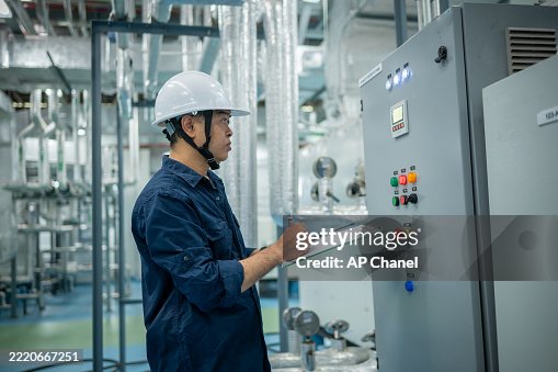Industrial technicians working electrical control cabinet panel is well-organized for manufacturing, HVAC, or power distribution and organized technical environment. Industrial technicians working electrical control cabinet panel is well-organized for manufacturing, HVAC, or power distribution and organized technical environment.