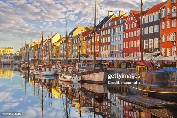 nyhavn harbour in the morning with colorful historic buildings and sailboats in copenhagen, denmark - copenhagen nyhavn stock pictures, royalty-free photos & images