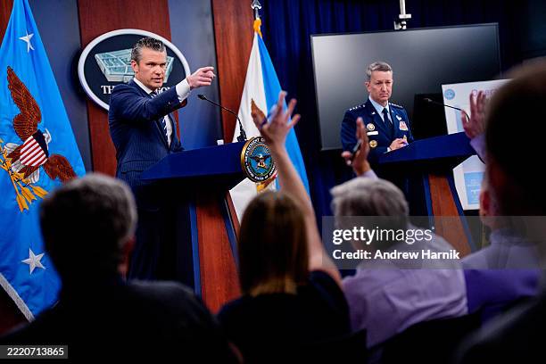 Defense Secretary Pete Hegseth , accompanied by Chairman of the Joint Chiefs of Staff Air Force Gen. Dan Caine , takes a question from a reporter...