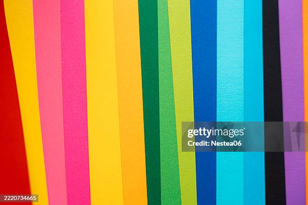 ertical stripes of rainbow-colored neon paper, bold and vibrant.