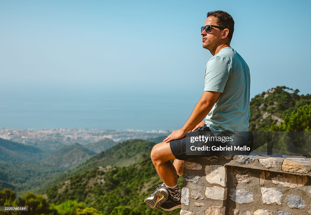 Man on top of mountain in Marbella