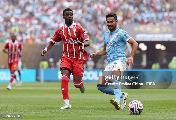 Malsa Mickael Malsa of Wydad AC battles for possession with Ilkay Guendogan ...
