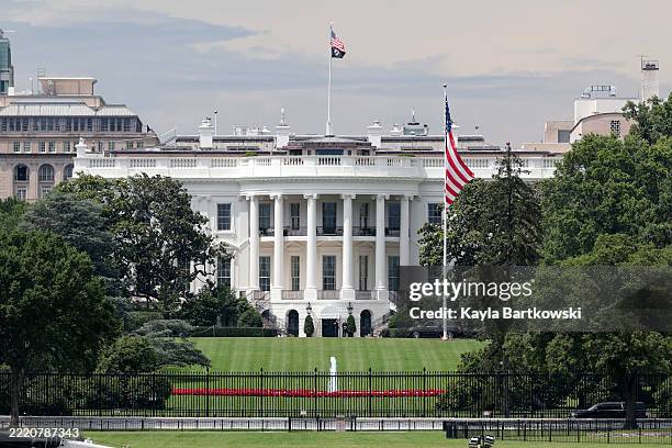 Large flag is seen after a flag raising ceremony for the newly installed flagpole on the South Lawn of the White House on June 18, 2025 in...