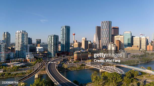 downtown calgary skyline with bow river and bridges on a clear summer morning - calgary stock pictures, royalty-free photos & images