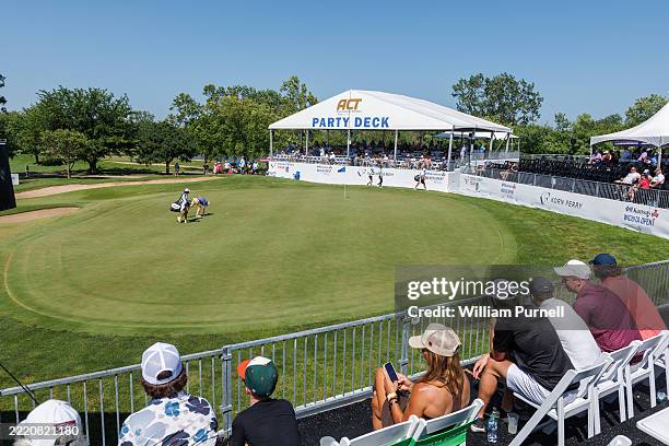 Golf fans watch play from the party deck on the seventeenth green during the final round of the Blue Cross and Blue Shield of Kansas Wichita Open...