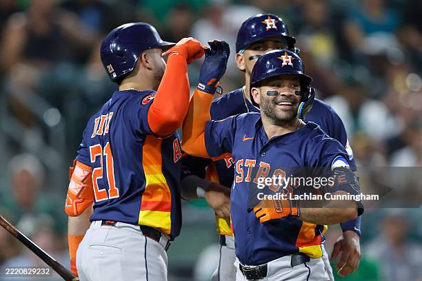 Jose Altuve of the Houston Astros celebrates with Yainer Diaz after hitting a three-run home run in the top of the sixth inning against the Athletics...