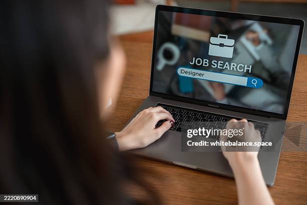 close-up shot of woman looking at online job search website on her laptop - flexible screen stock pictures, royalty-free photos & images