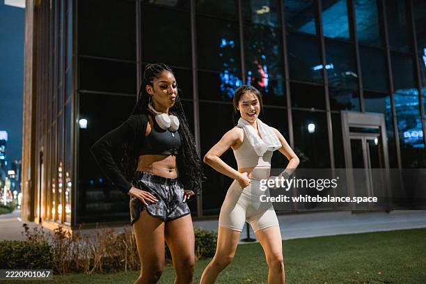 two friends filming a fun dance video together after their workout session - she done him wrong stock pictures, royalty-free photos & images