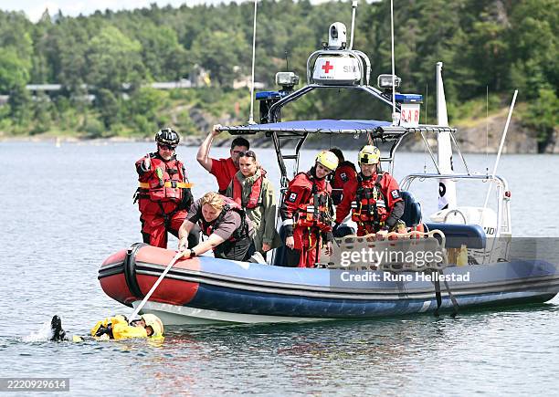 Norwegian Princess Ingrid Alexandra and Prince Sverre Magnus take part in a life saving exercise during their visit to the Red Cross Summer Emergency...
