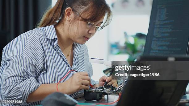 quality control engineer conducts circuit tests on the main distribution board at a production line, ensuring reliability for camera systems and installations. - lead testing stock pictures, royalty-free photos & images