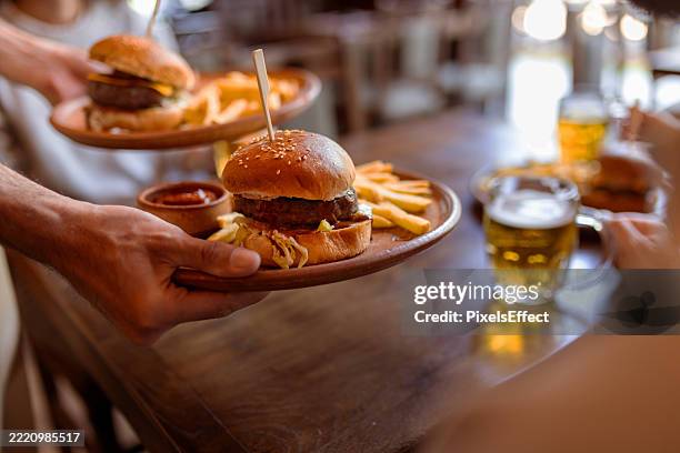 burger and fries served fresh at bar counter - pub food stock pictures, royalty-free photos & images