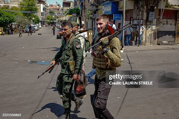 Armed Syrian security forces are on the scene on the outskirts of Damascus, Syria, on June 23 where a suicide bomber, allegedly linked to ISIS, blew...