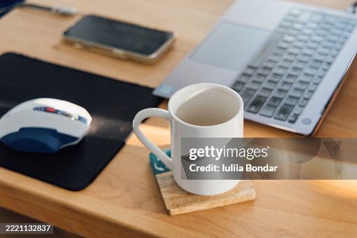 Coffee Break at Home Office Desk with Laptop and Mouse Coffee Break at Home Office Desk with Laptop and Mouse