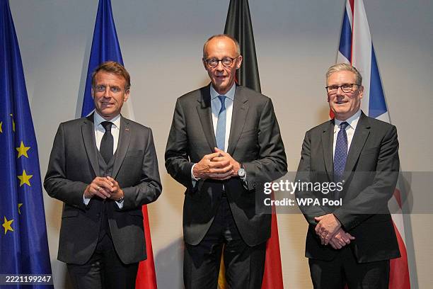 French President Emmanuel Macron, Germany's Chancellor Friedrich Merz and British Prime Minister Keir Starmer pose for the media at a hotel prior to...
