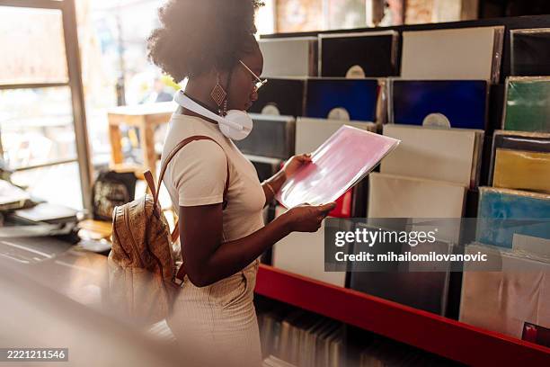 interracial woman browsing vinyl records in retro store - record store stock pictures, royalty-free photos & images