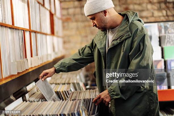side view of a man in vinyl record store - record store stock pictures, royalty-free photos & images