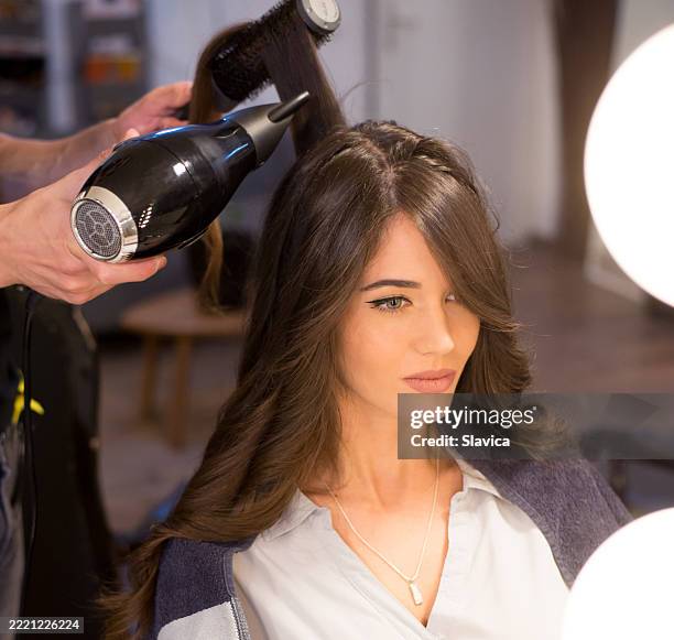 beautiful brunette getting new hairstyle in the hair salon - celebrity stylist stock pictures, royalty-free photos & images