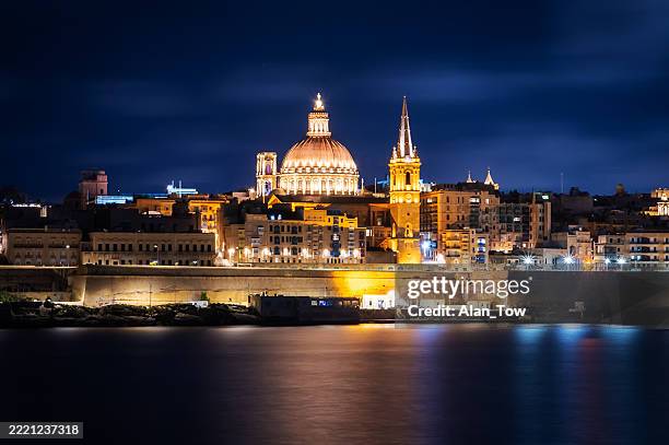 night view from marsamxett harbour to cathedral of saint paul valletta, malta - valletta stock pictures, royalty-free photos & images