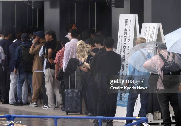 People form a line at the venue of a general shareholders meeting for Fuji Media Holdings Inc. In Tokyo on June 25 following a sexual misconduct...