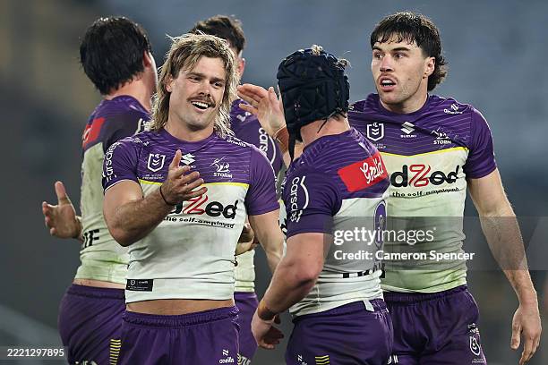 Ryan Papenhuyzen of the Storm celebrates with team mates after kicking a field goal to win the round 16 NRL match between South Sydney Rabbitohs and...