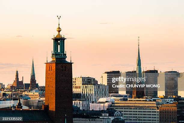 stockholmer rathausturm und riddarholmen-kirche bei sonnenuntergang - riddarfjarden stock-fotos und bilder