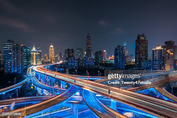 the illuminated elevated highway intersection in shanghai - road intersection stock pictures, royalty-free photos & images