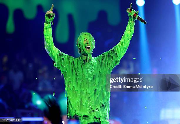 Mgk gets slimed while performing onstage during the Nickelodeon Kids' Choice Awards 2025 at Barker Hangar on June 21, 2025 in Santa Monica,...