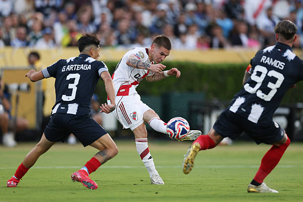 Franco Mastantuono of CA River Plate kicks the ball past Gerardo Arteaga and Sergio Ramos of CF Monterrey during the FIFA Club World Cup 2025 group E...