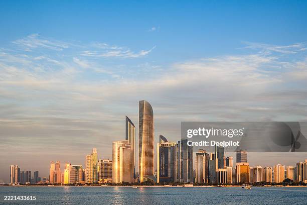 abu dhabi city skyline at sunset, united arab emirates - abu dhabi skyline stock pictures, royalty-free photos & images