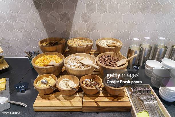 breakfast cereal buffet with nuts and dried fruit - raisin bran stock pictures, royalty-free photos & images
