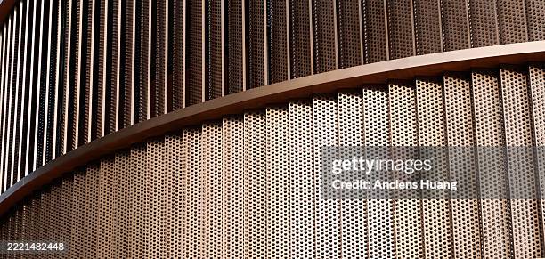 close-up of vertical metal slats on contemporary building facade, geometric pattern in urban architecture. modern design and structure. - architectonisch element stockfoto's en -beelden