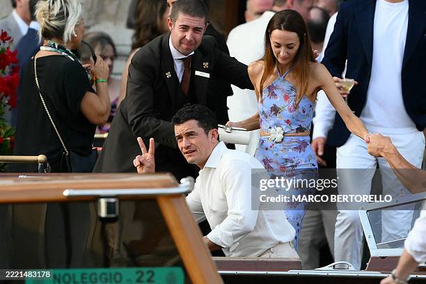 British actor Orlando Bloom and guest get on a taxi boat at the Gritti Palace Hotel ahead of the wedding of Amazon's founder Jeff Bezos with Lauren...