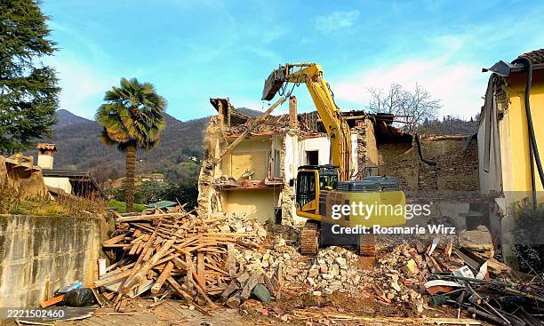 huge excavator working on demolition of old house - demolishing stock pictures, royalty-free photos & images