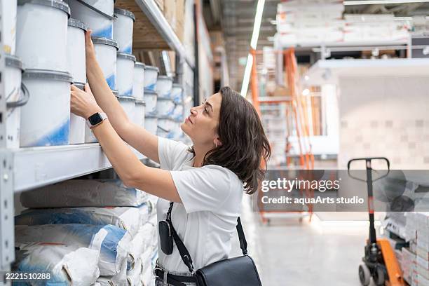 woman shopping in hardware store - hardware store stock pictures, royalty-free photos & images