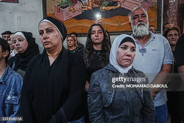 People grieve for those who were killed and wounded in Mar Elias Church attack in Damascus, Syria, on June 23 where a suicide bomber, allegedly...