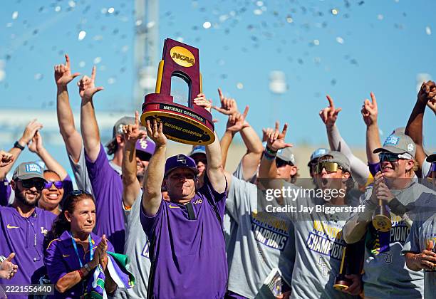 Head coach Jay Johnson of the LSU Tigers hoists the championship trophy after defeating the Coastal Carolina Chanticleers to win the NCAA College...