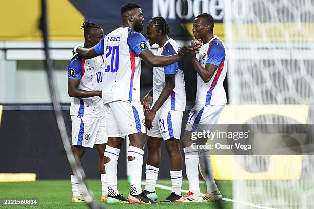 Don Louicius of Haiti celebrates with his teammates after scoring his teammates first goal during the Group Stage - Group D match between United...
