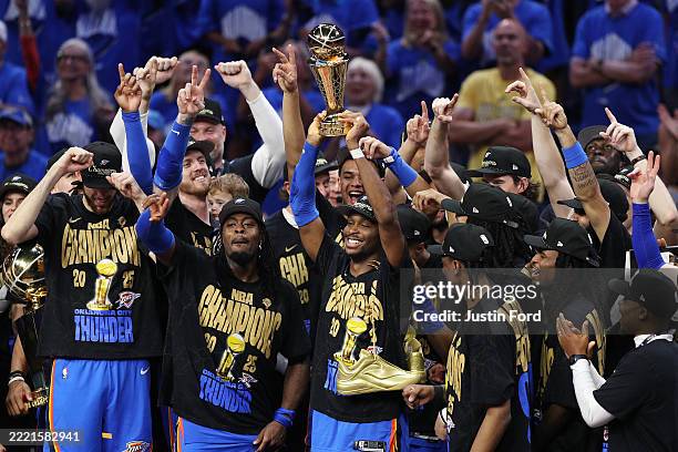 Shai Gilgeous-Alexander of the Oklahoma City Thunder celebrates with the Bill Russell NBA Finals Most Valuable Player trophy after defeating the...