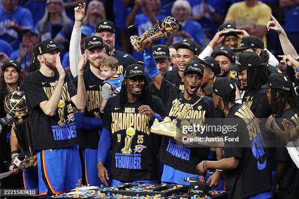 Shai Gilgeous-Alexander of the Oklahoma City Thunder celebrates with the Bill Russell NBA Finals Most Valuable Player trophy after defeating the...